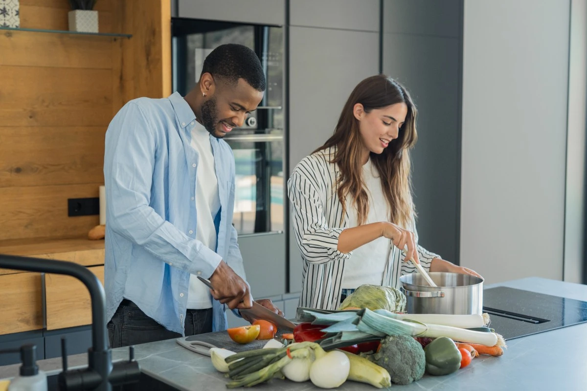 Couple preparing vegetables in the kitchen.